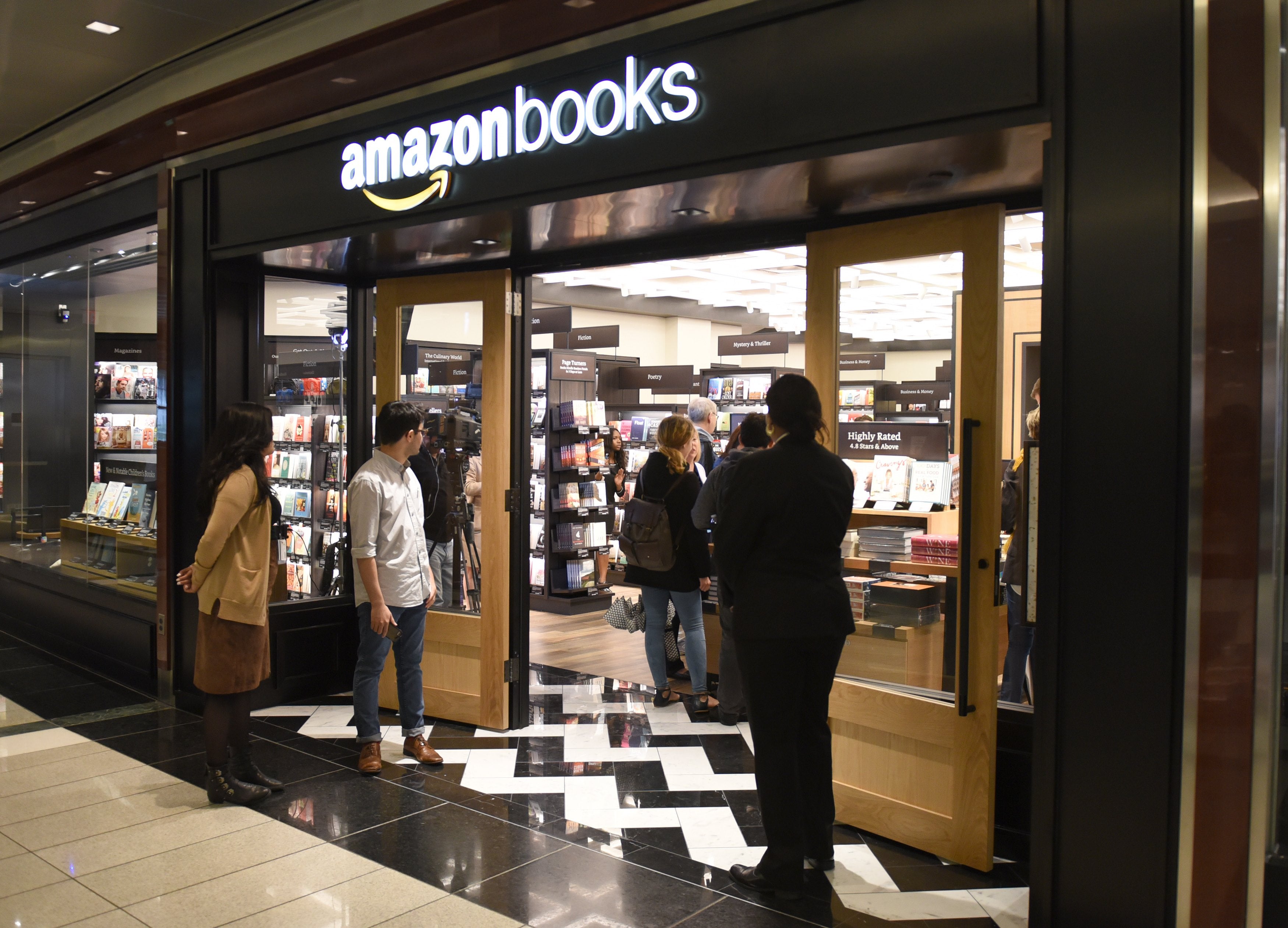 Customers arrive at Amazon Books in Manhattan's Time Warner Center on May 25, 2017 as the online retailing giant Amazon.com Inc. opens its first New York City bookstore.