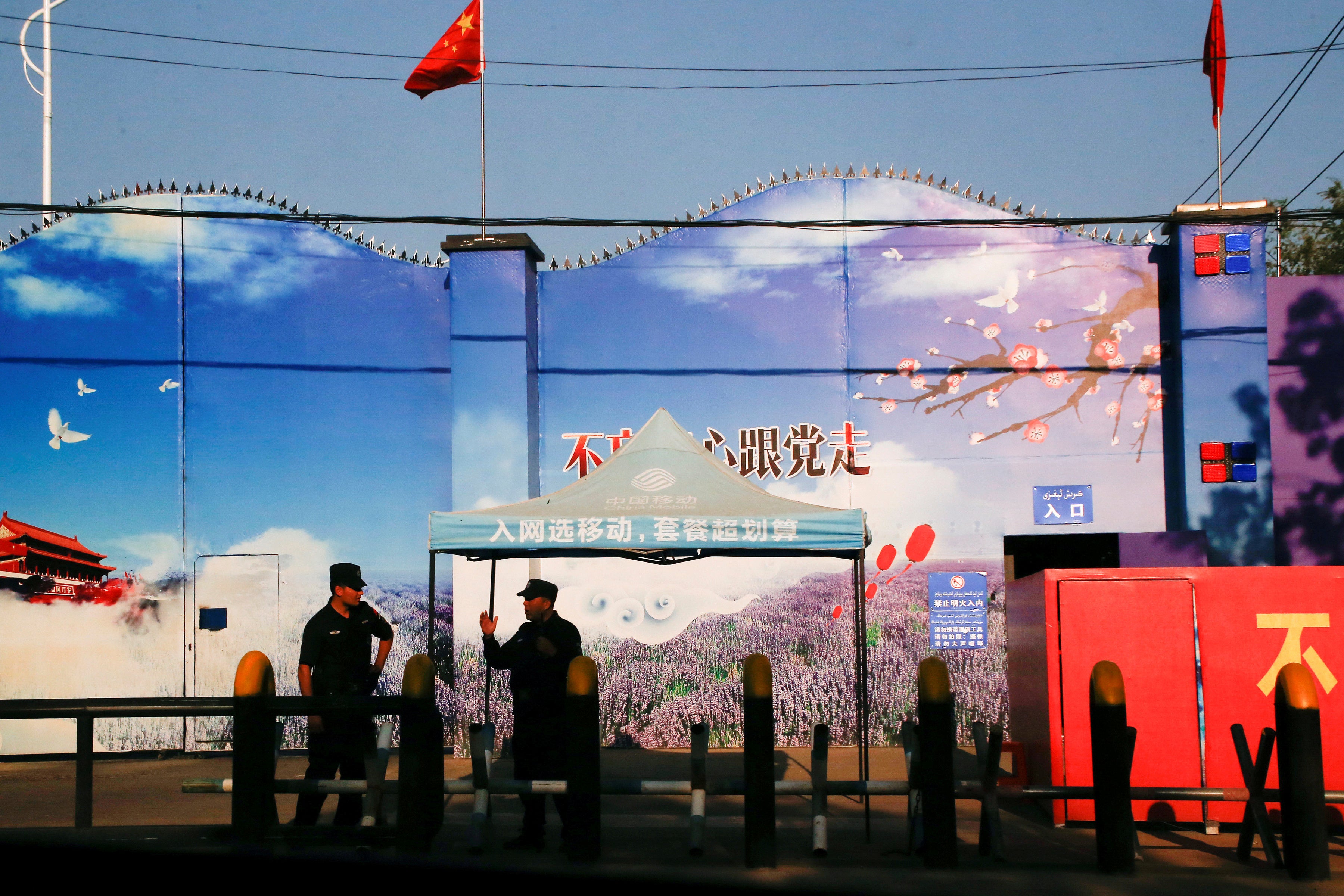 <p>File: Security guards stand at the gates of what is officially known as a ‘vocational skills education centre’ in Huocheng County in Xinjiang, China</p>