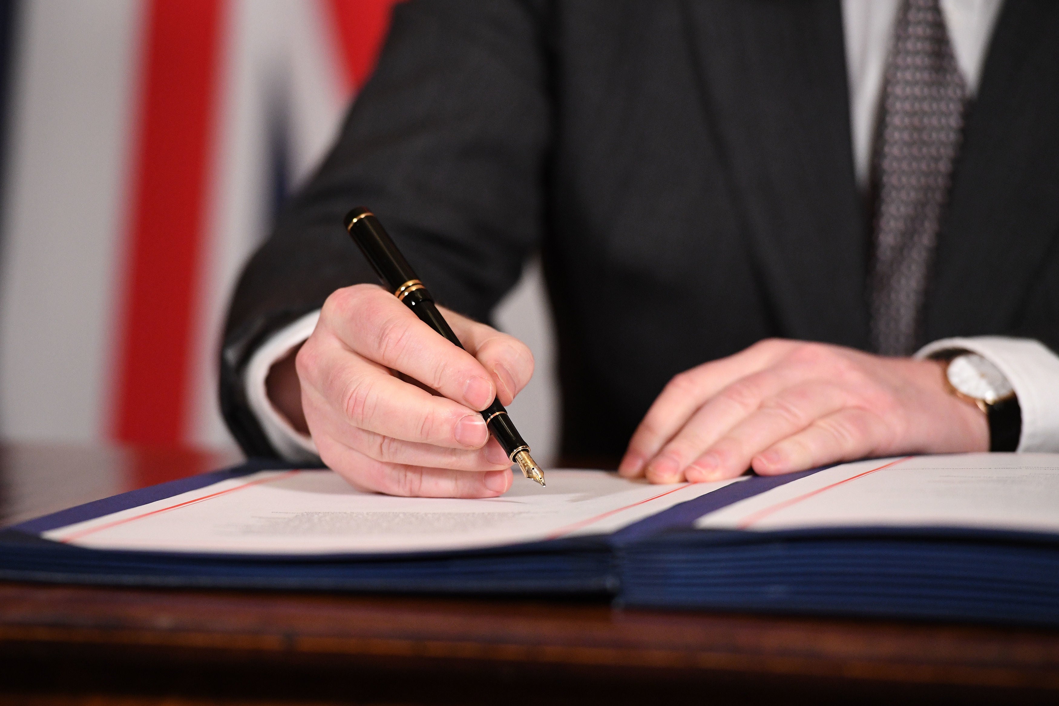 Boris Johnson signing the EU-UK Trade and Cooperation Agreement on 30 December