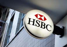 HSBC to cut jobs and resume dividend payments as profits slump by a third