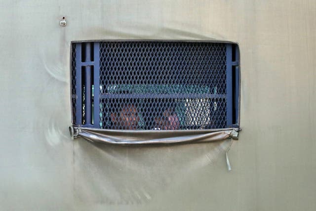 <p>Myanmar migrants to be deported from Malaysia are seen inside an immigration truck, in Lumut, Malaysia on 23 February, 2021</p>