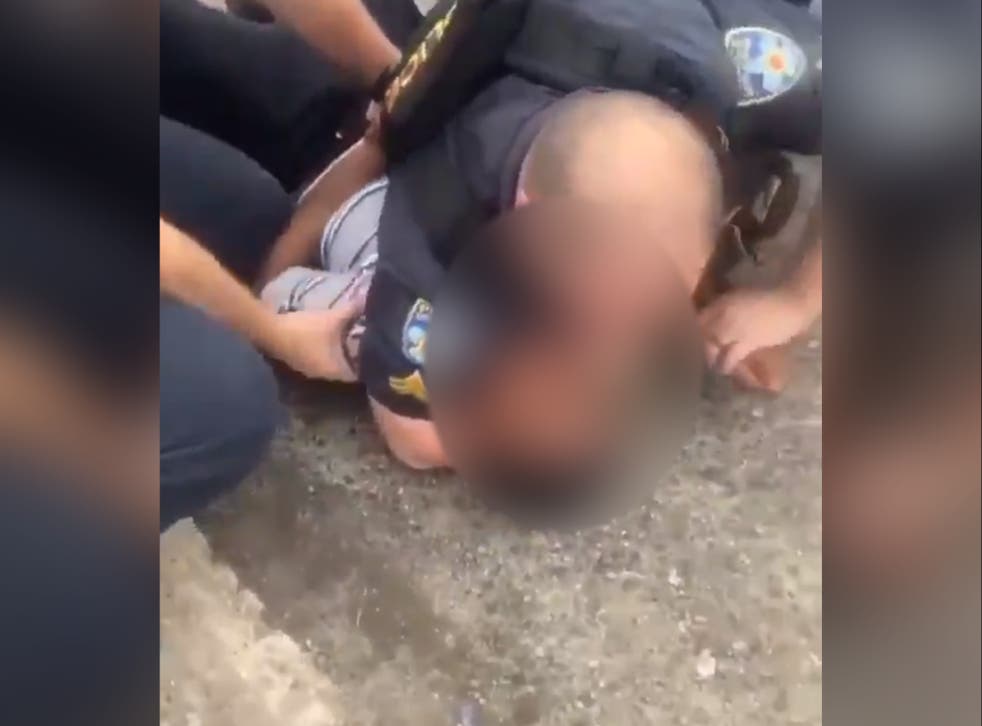 <p>In footage that was widely shared following the incident, an officer can be seen restraining a boy on the ground before sitting him up and putting his hands behind his back</p>