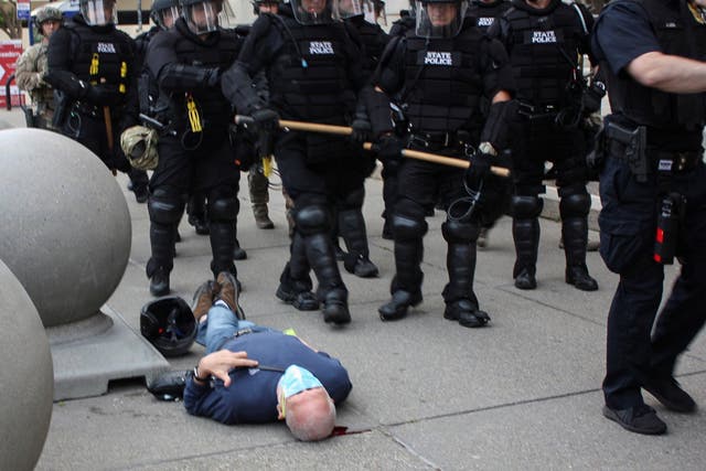 <p>Martin Gugino, a 75-year-old protester, lays on the ground after he was shoved by two Buffalo, New York, police officers during a protest against the death in Minneapolis police custody of George Floyd in Niagara Square in Buffalo, New York, on 4 June 2020</p>