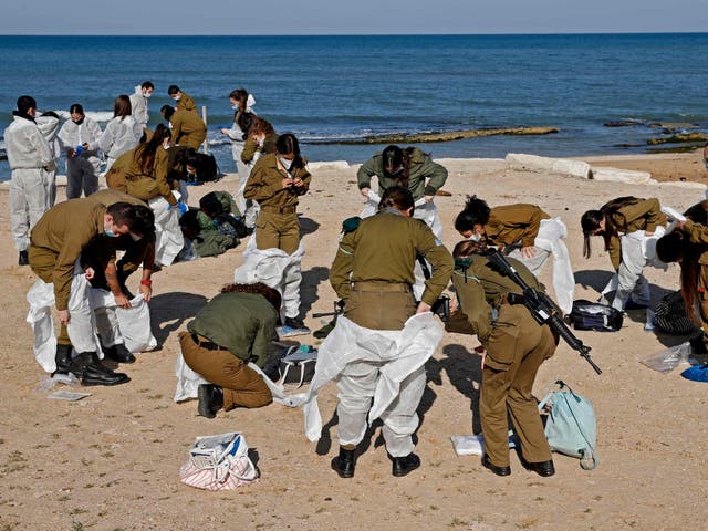 Israeli soldiers arrive to clean up the contaminated Sharon beach national park, north of Tel Aviv city, on February 22 2021