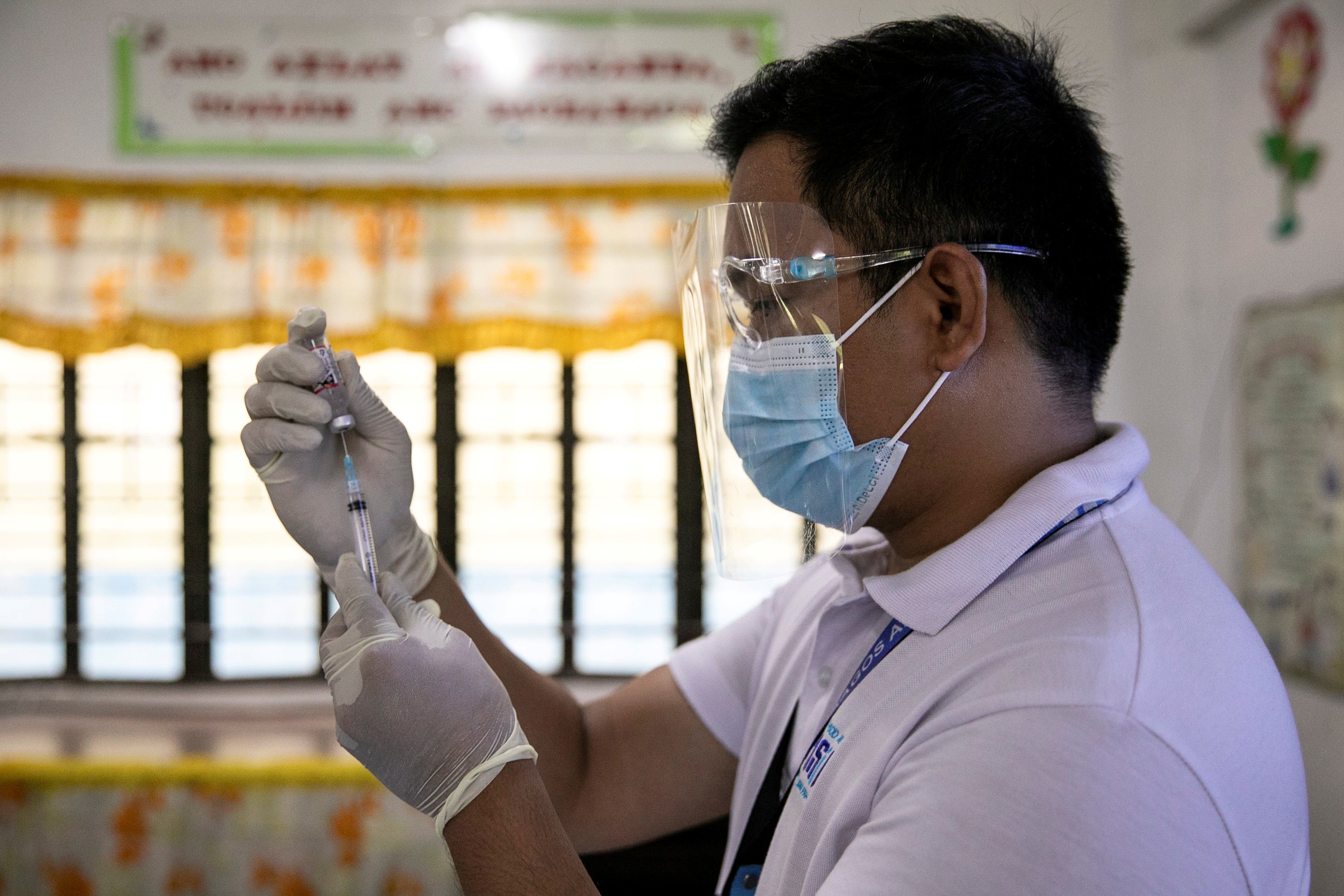 A health worker participates in a simulation for COVID-19 vaccination in preparation for its arrival, at an elementary school turned vaccination command center in Pasig City, Metro Manila, Philippines