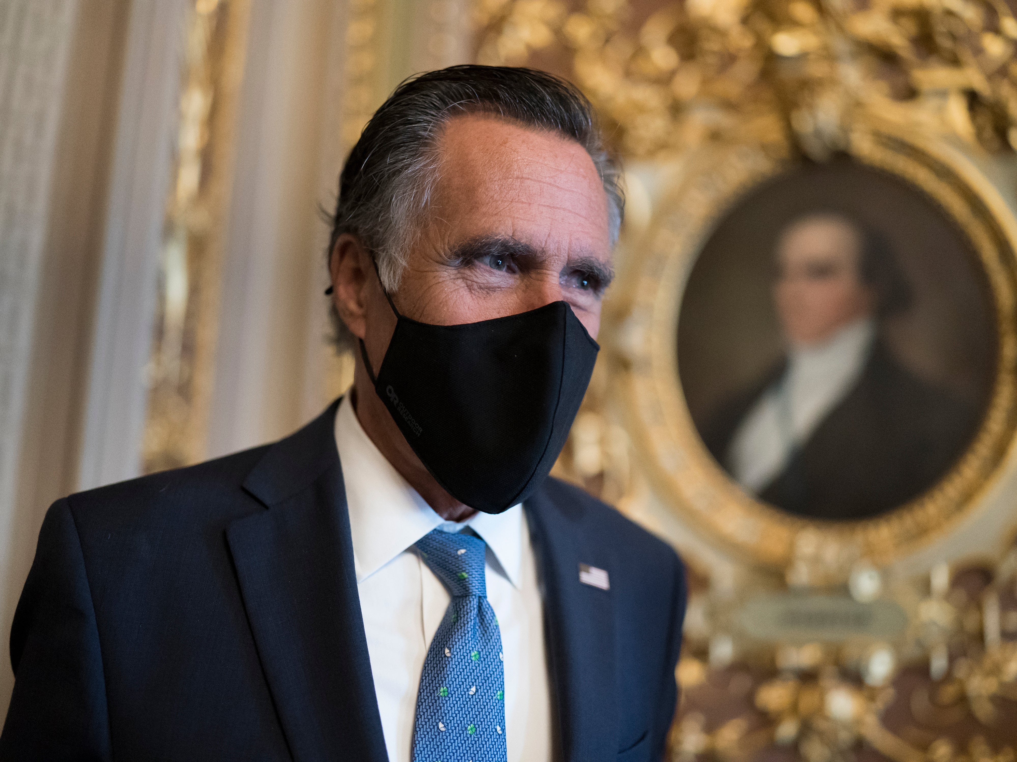 Mitt Romney, R-Utah, pauses to answer questions from reporters as senators arrive to vote on President Joe Biden’s nominee for United Nation’s ambassador, Linda Thomas-Greenfield, at the Capitol in Washington, on Tuesday 23 February 2021