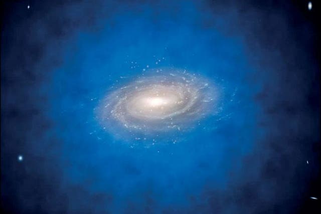 Artist’s impression of a spiral galaxy embedded in a larger distribution of invisible dark matter, known as a dark matter halo (coloured in blue)