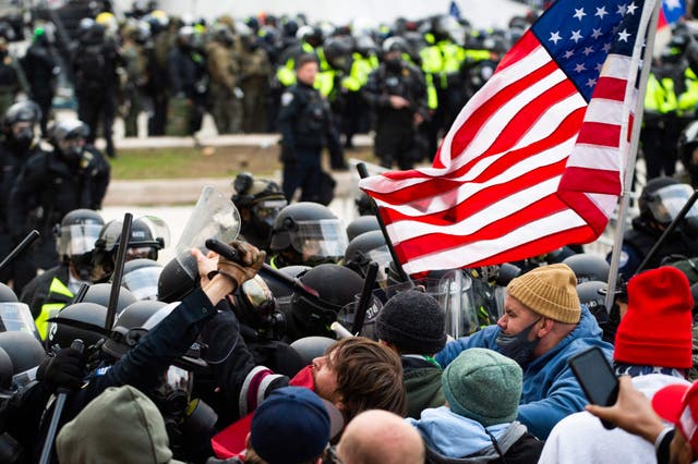 Supporters of US President Donald Trump fight with riot police outside the Capitol building on January 6, 2021 in Washington, DC
