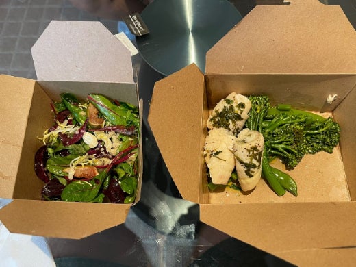 Food is served to guests in cardboard containers