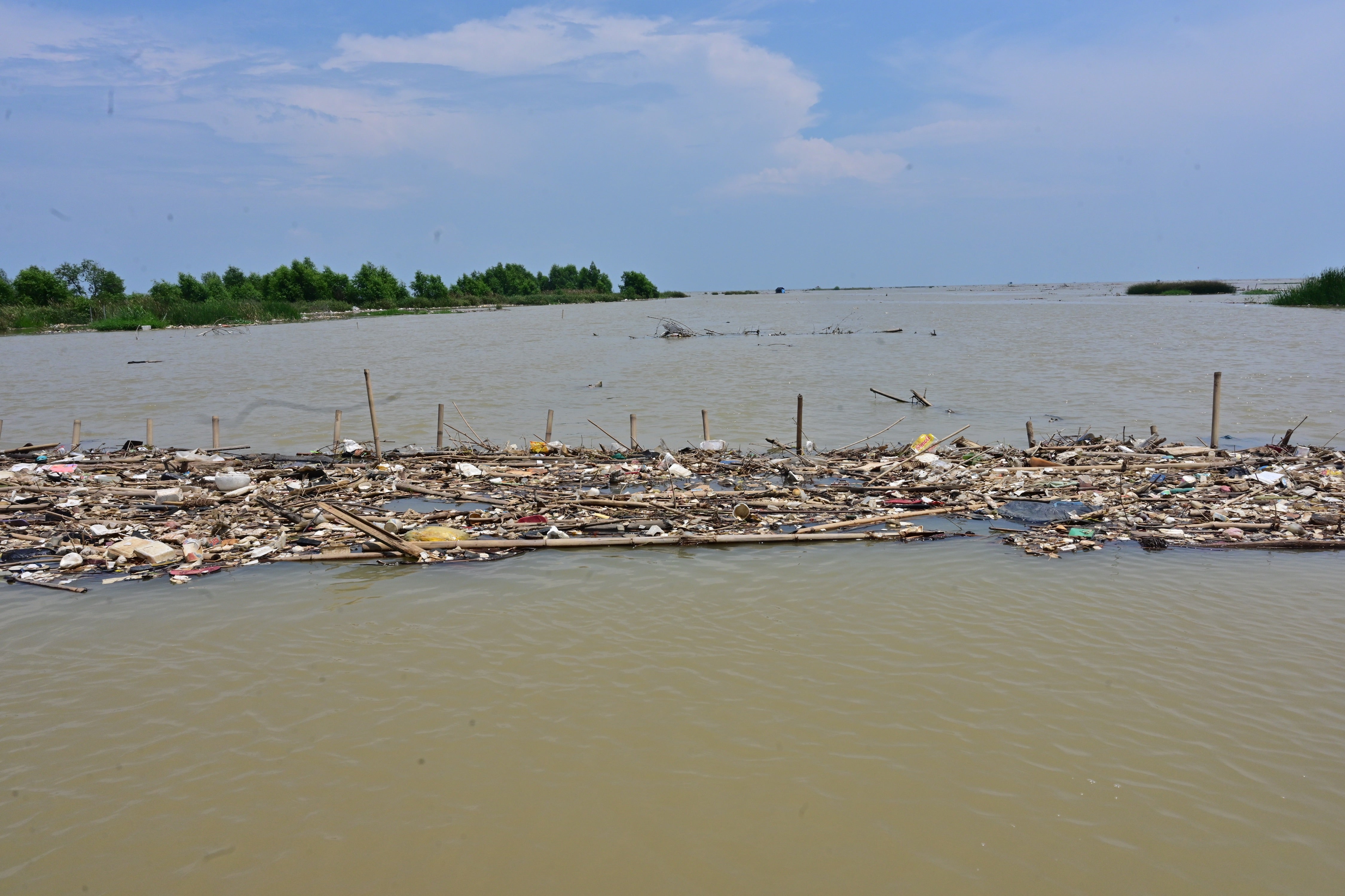This picture taken in October 2020 shows rubbish floating in the waters off the coast near Teluk Naga