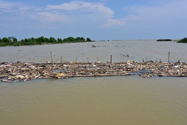 <p>This picture taken in October 2020 shows rubbish floating in the waters off the coast near Teluk Naga</p>