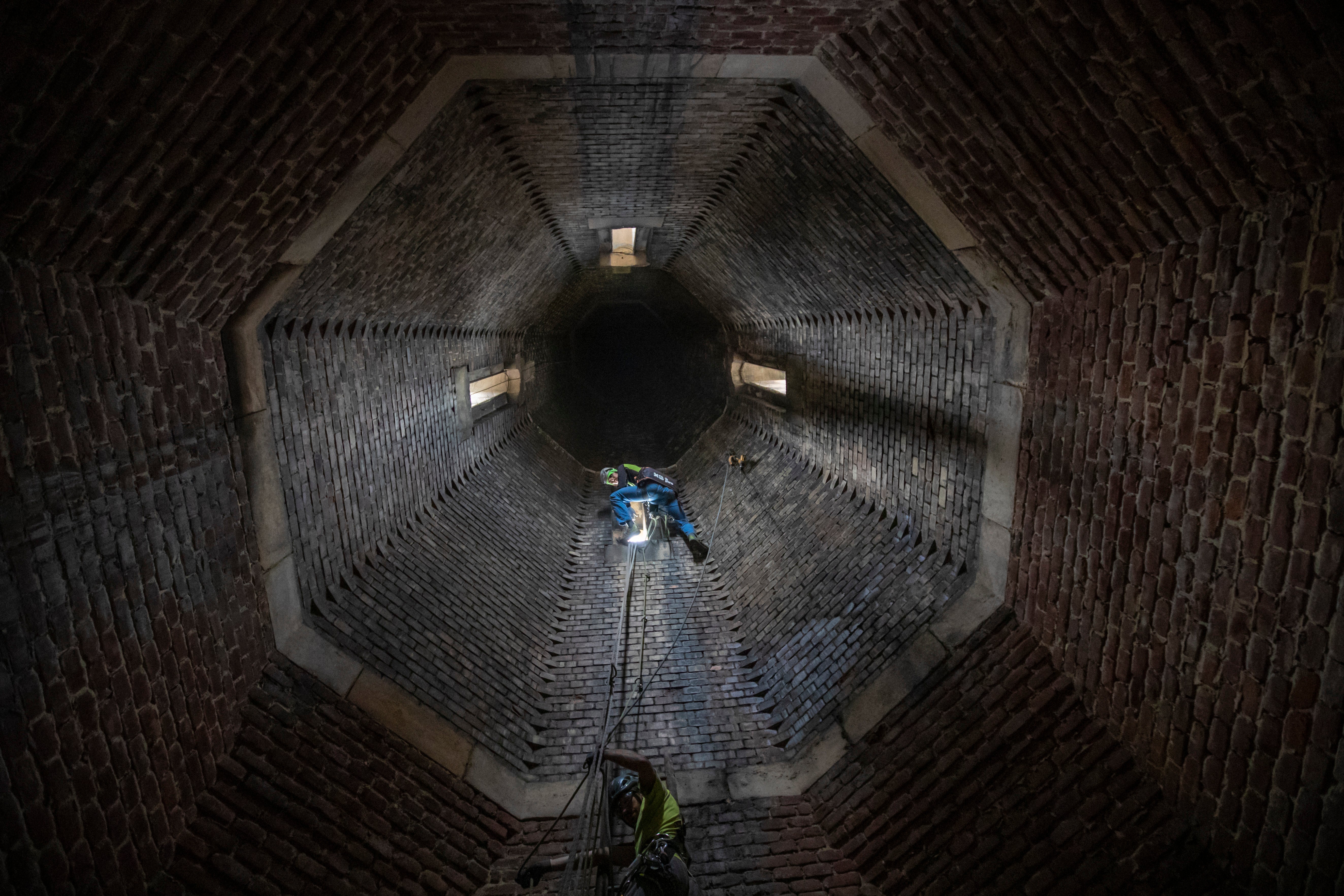 A mountaineer prepares his way to the tower for removing dials during maintenance of the tower's clock at the Church of St Ludmila in Prague