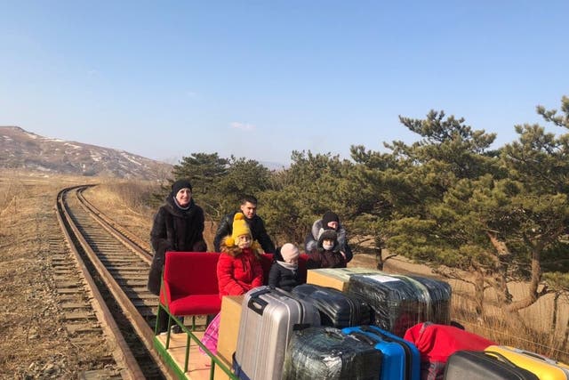 <p>Russian diplomat pictured crossing North Korean border on handcar with his family</p>
