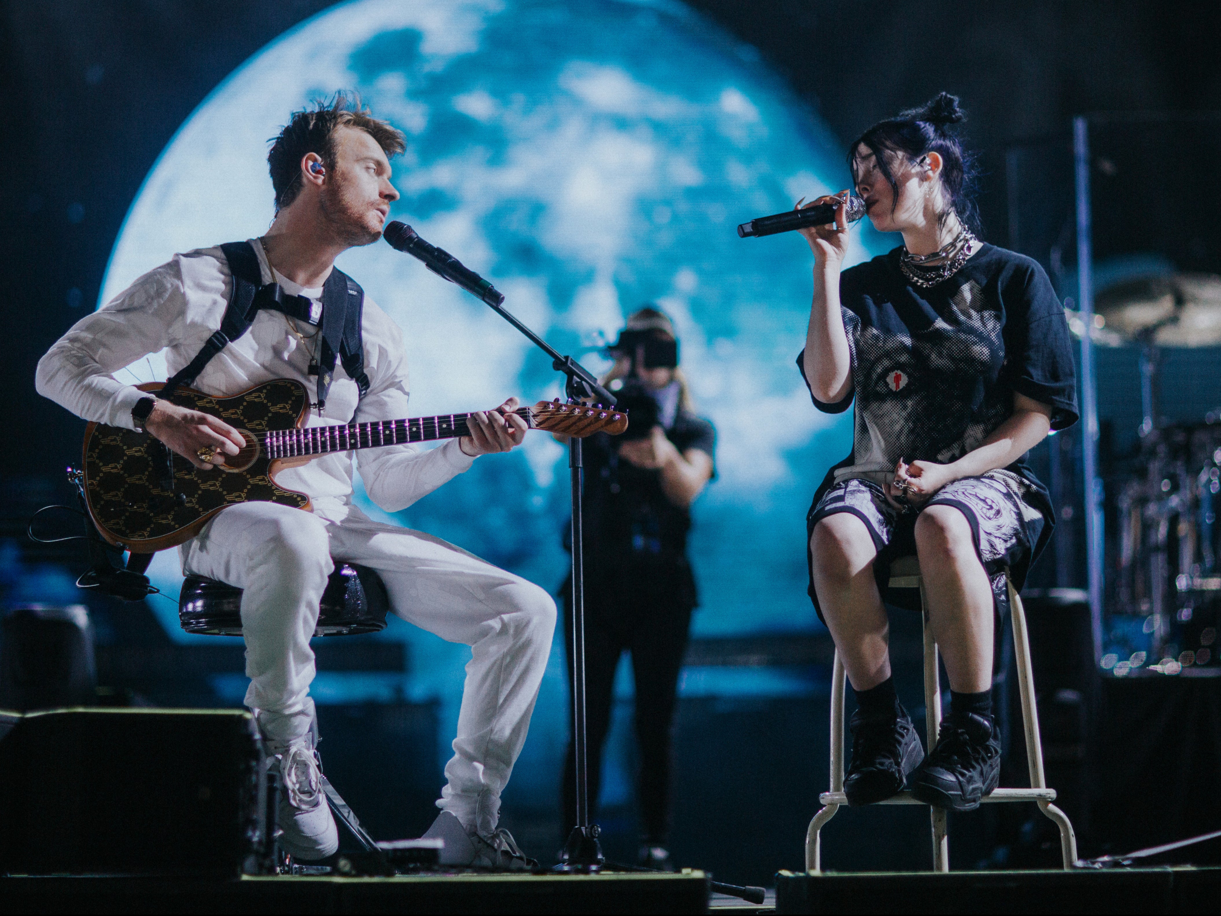 Finneas and Billie performing onstage together