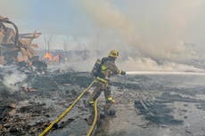 Fire visible across Los Angeles burns commercial yard, buses