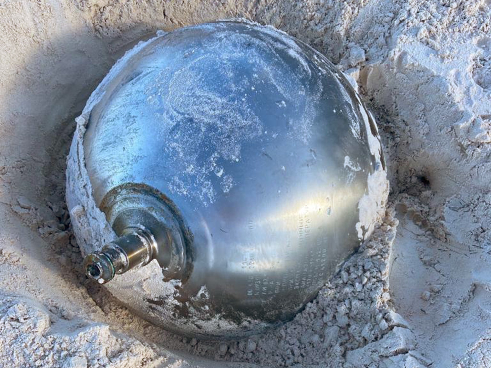 Manon Clarke spotted the 41kg reflective ball poking out of the sand while walking with her family at Harbour Island