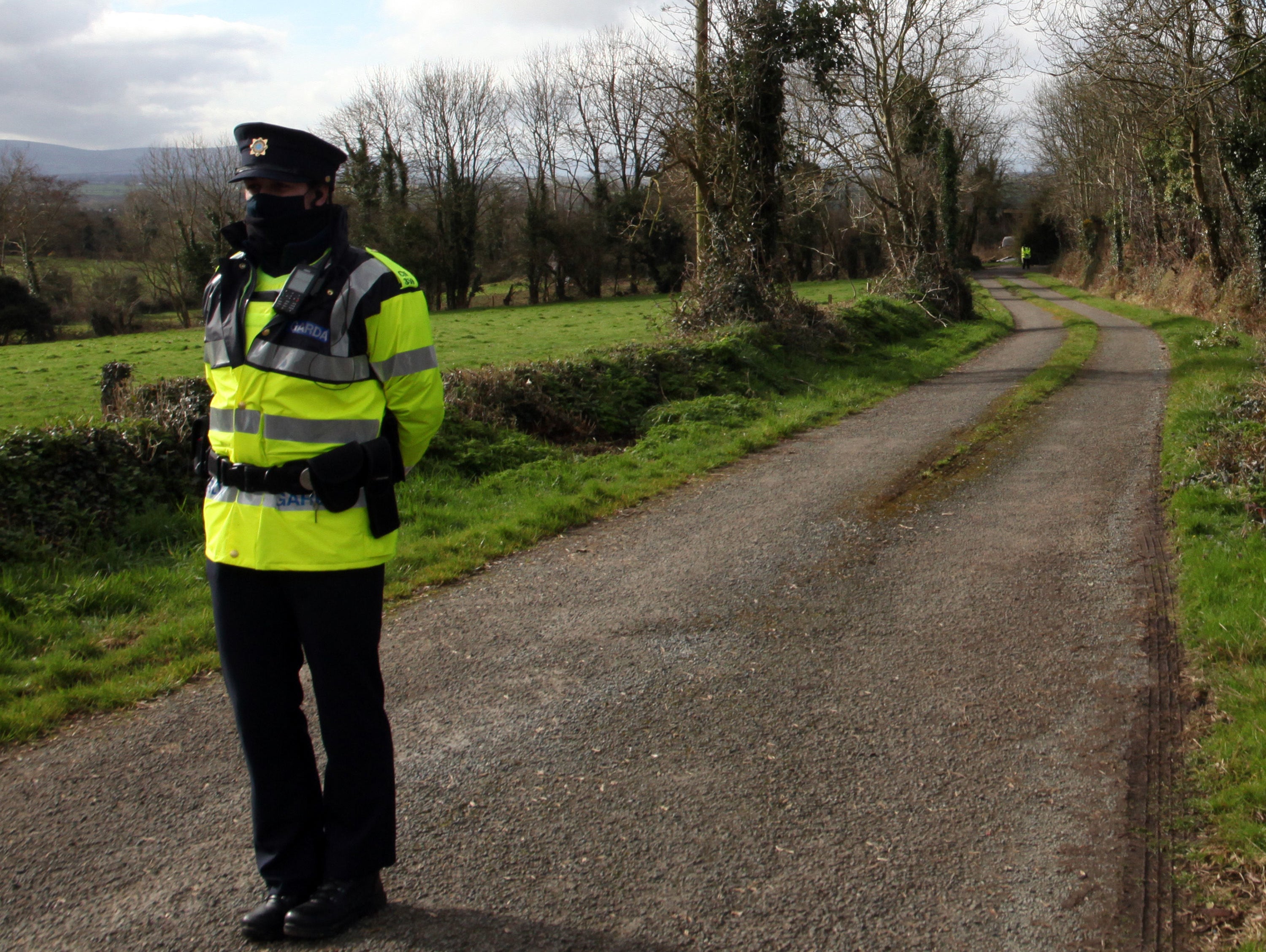 Garda at the scene near Curraghgorm, County Cork, following the deaths of three brothers.