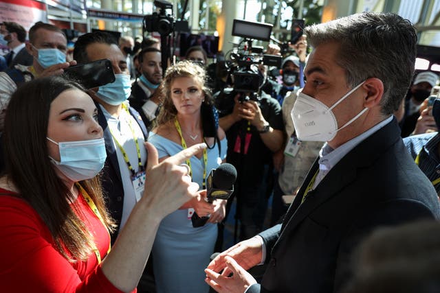 A woman argues with CNN reporter Jim Acosta outside CPAC on Friday, Feb. 26, 2021 in Orlando, Fla.  (Sam Thomas/Orlando Sentinel via AP)