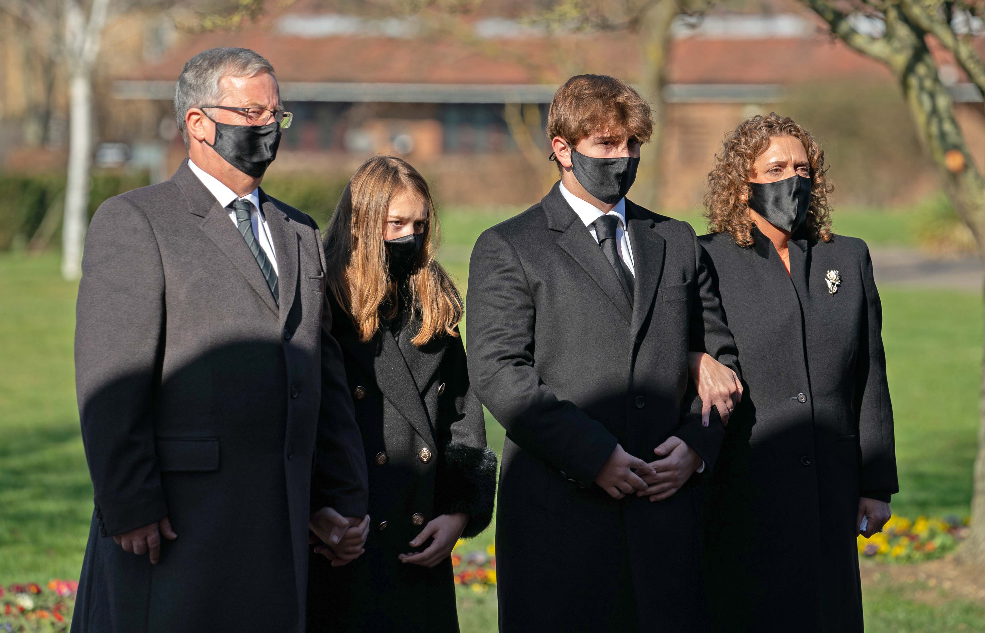 The family of Captain Sir Tom Moore: son-in-law Colin Ingram, granddaughter Georgia, grandson Benjie and daughter Hannah Ingram-Moore arrive for his funeral at Bedford Crematorium