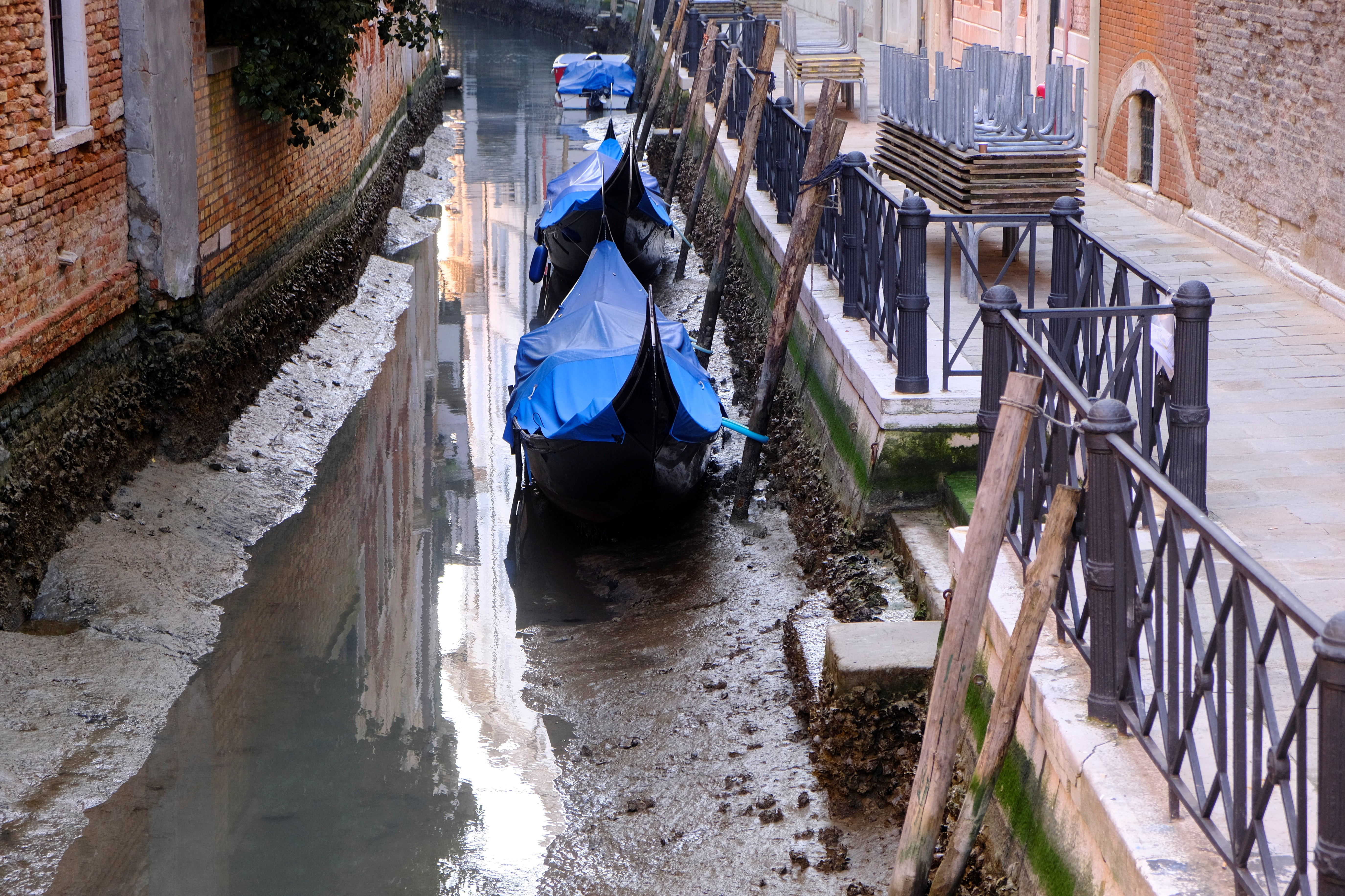 Gondolas are seen in a canal during an exceptionally low tide in the lagoon city of Venice