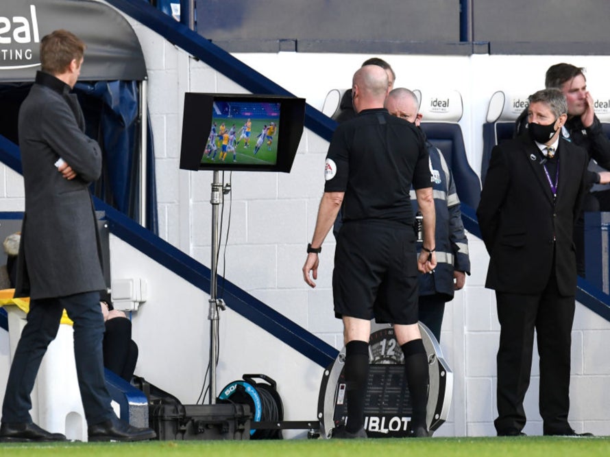 Lee Mason checks the VAR monitor