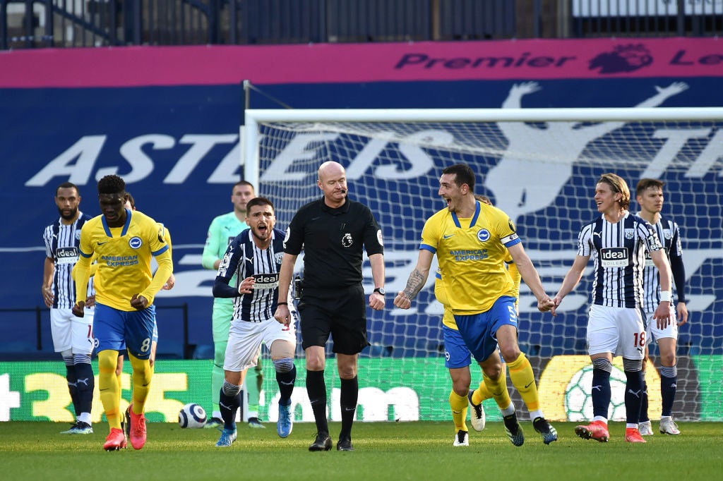 Lewis Dunk celebrates after a quickly taken free kick before the goal is disallowed following a VAR review