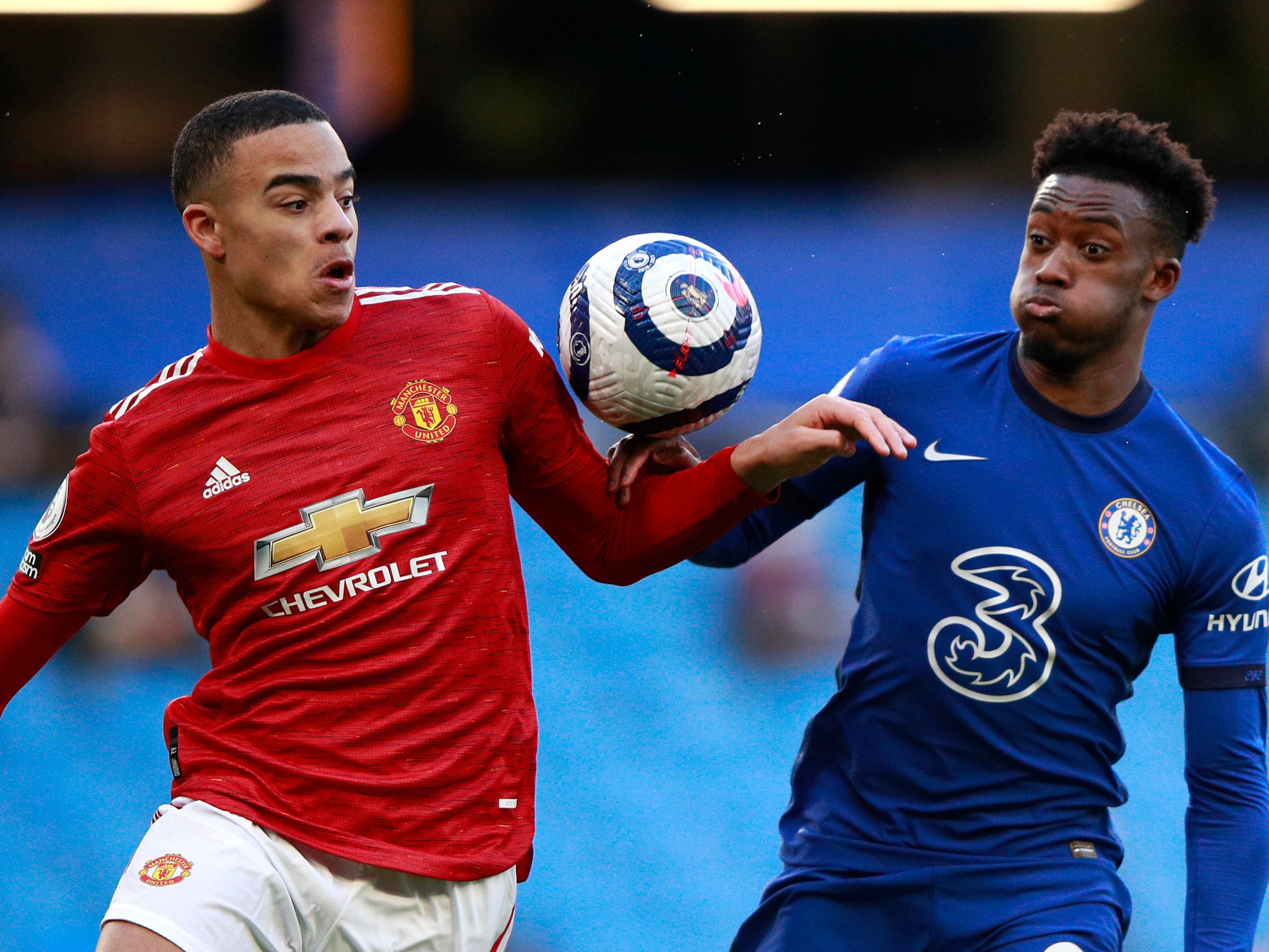 Chelsea’s Callum Hudson-Odoi, right, under pressure from Man United’s Mason Greenwood, brushes his hand against the ball