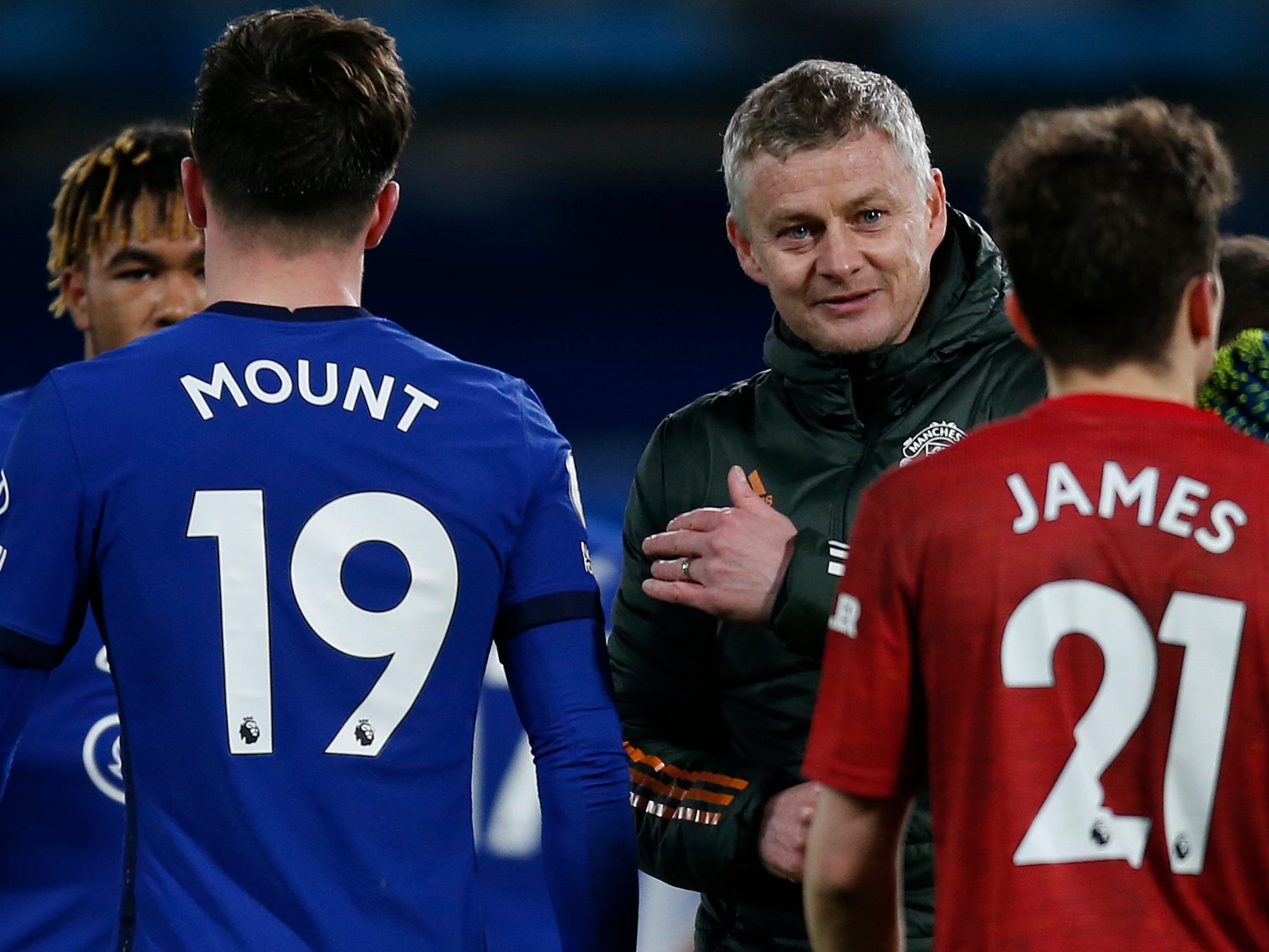 Ole Gunnar Solskjaer interacts with his players and Chelsea's at full-time