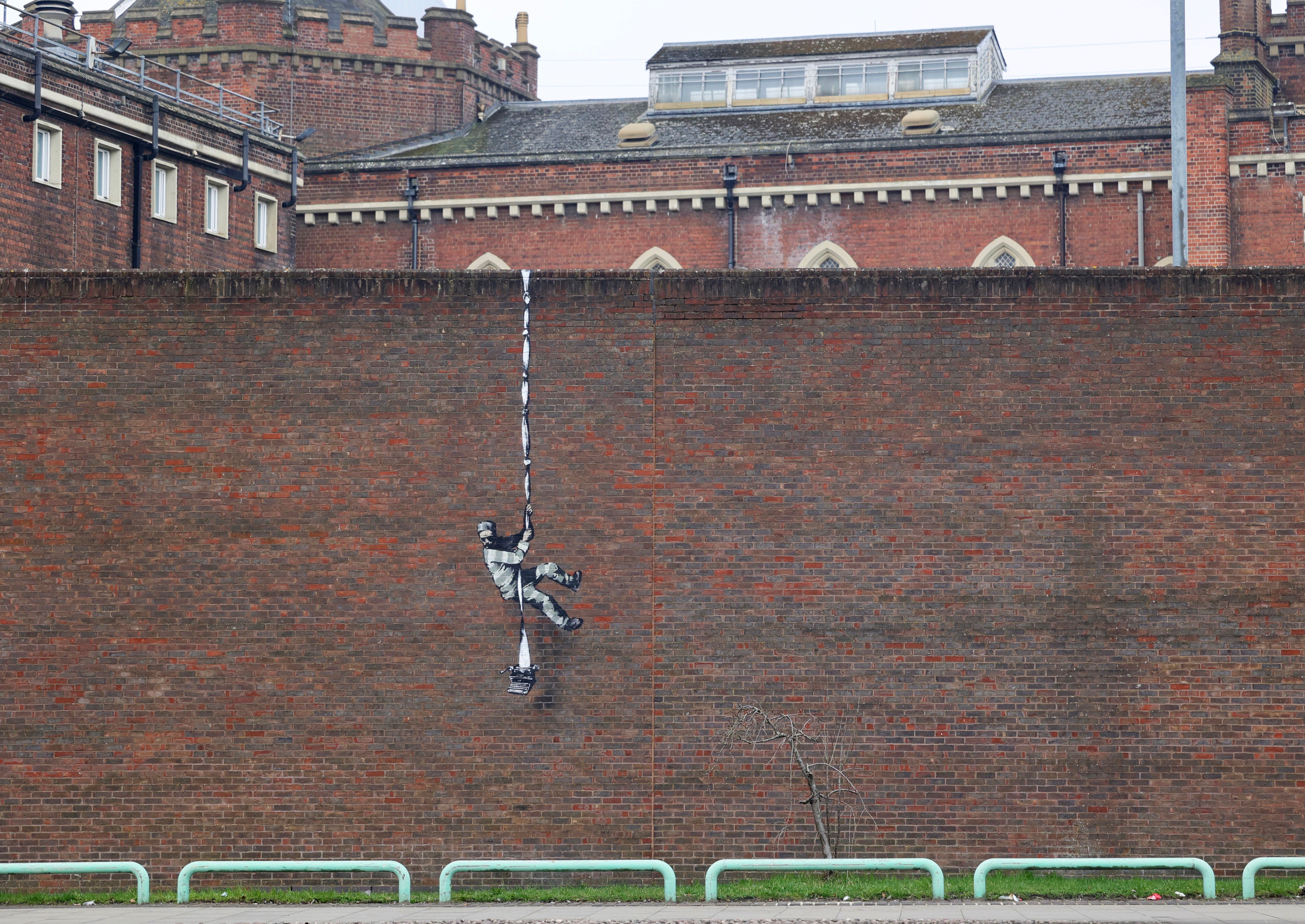 The figure is shown scaling the building with a typewriter