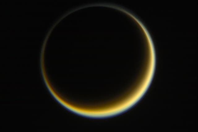 <p>The night side of Saturn’s moon Titan as viewed from Nasa’s Cassini spacecraft, highlighting the extended, hazy nature of the moon’s atmosphere</p>