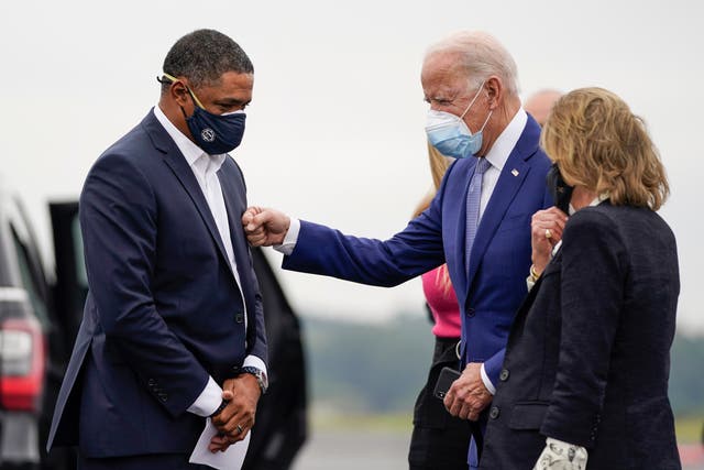 Cedric Richmond (D-LA) and Democratic presidential nominee Joe Biden greet each other as Biden arrives at Columbus Airport on 27 October 2020 in Columbus, Georgia