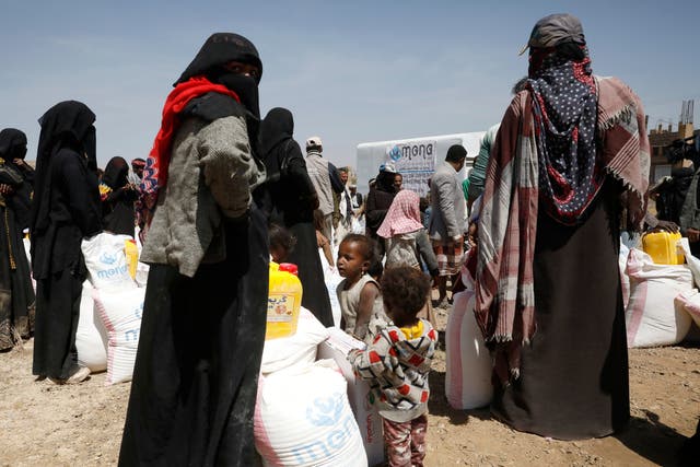 <p>Yemenis are given food rations at a camp in Sana’a</p>
