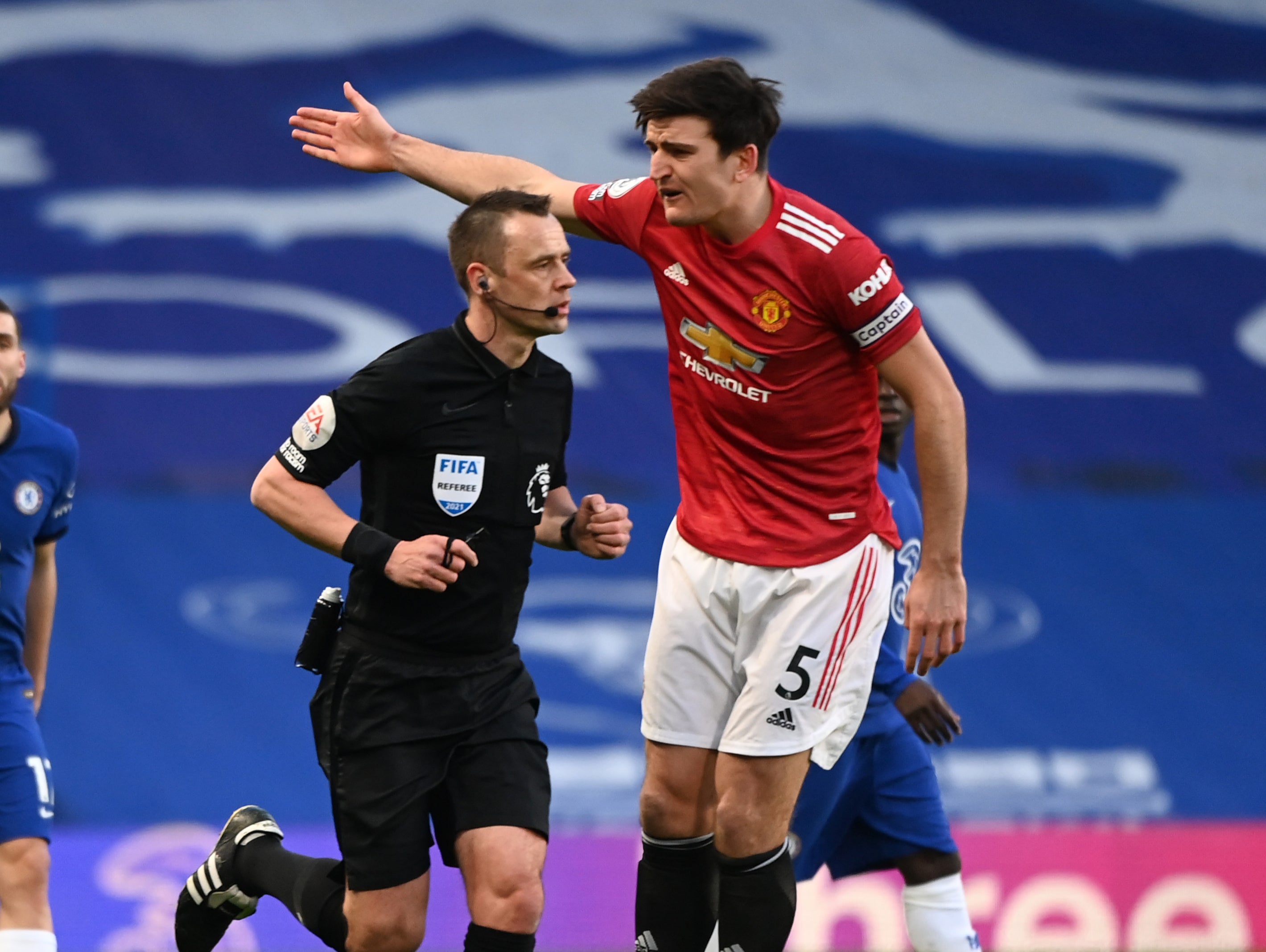 Referee Stuart Atwell and Manchester United captain Harry Maguire