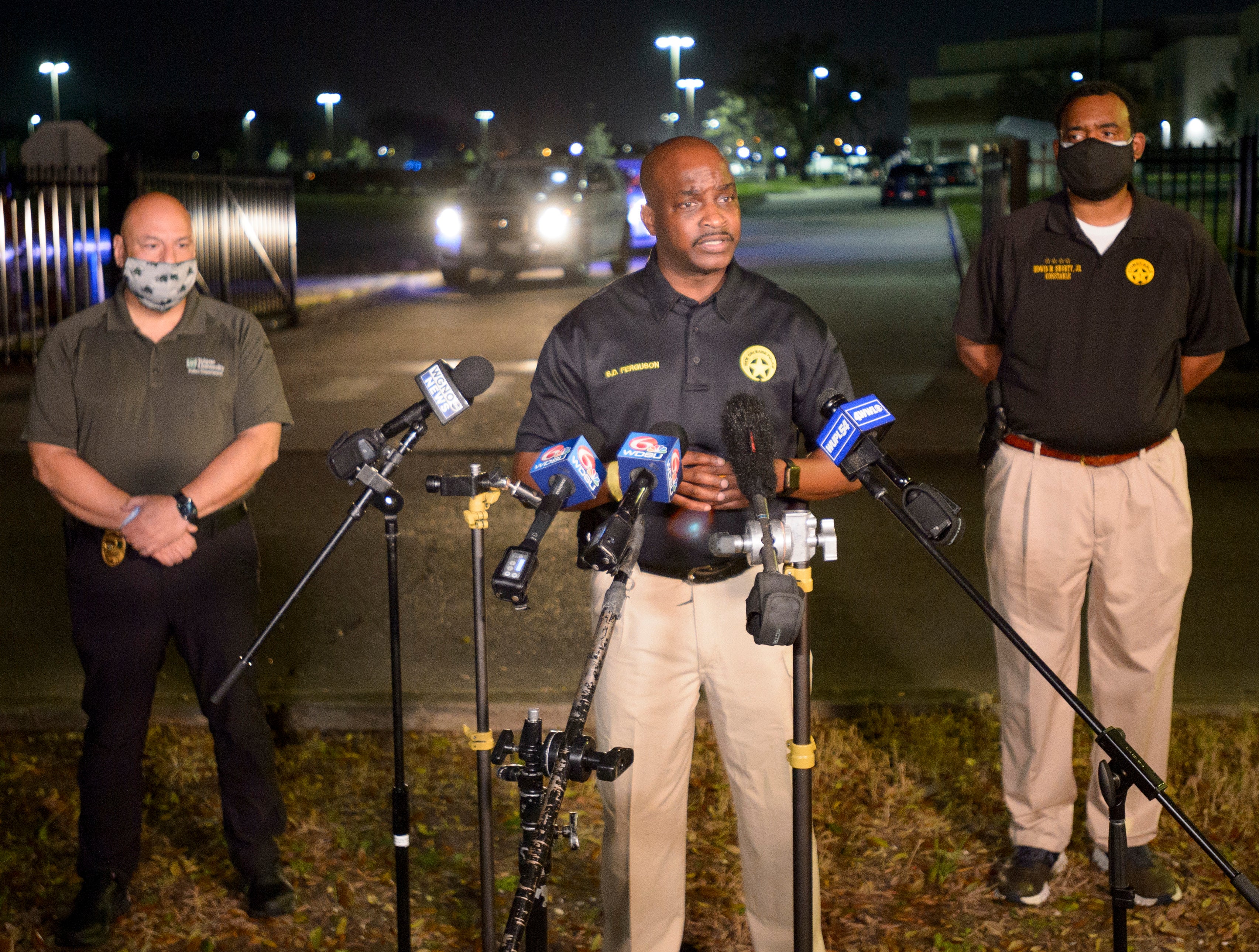 New Orleans Police Chief Shaun Ferguson, center, updates the media on the investigation of a shooting at George Washington Carver High School on 26 February 2021