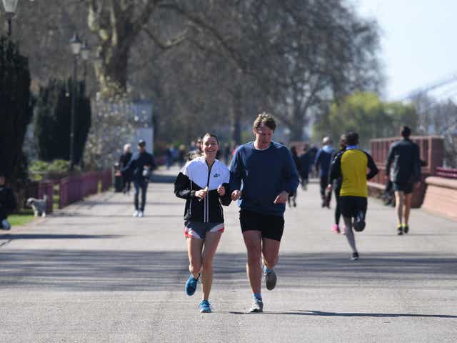 Joggers run through Battersea Park, London