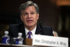 White supremacists on par with Isis as ‘top threat,’ FBI director says at Capitol riot hearing