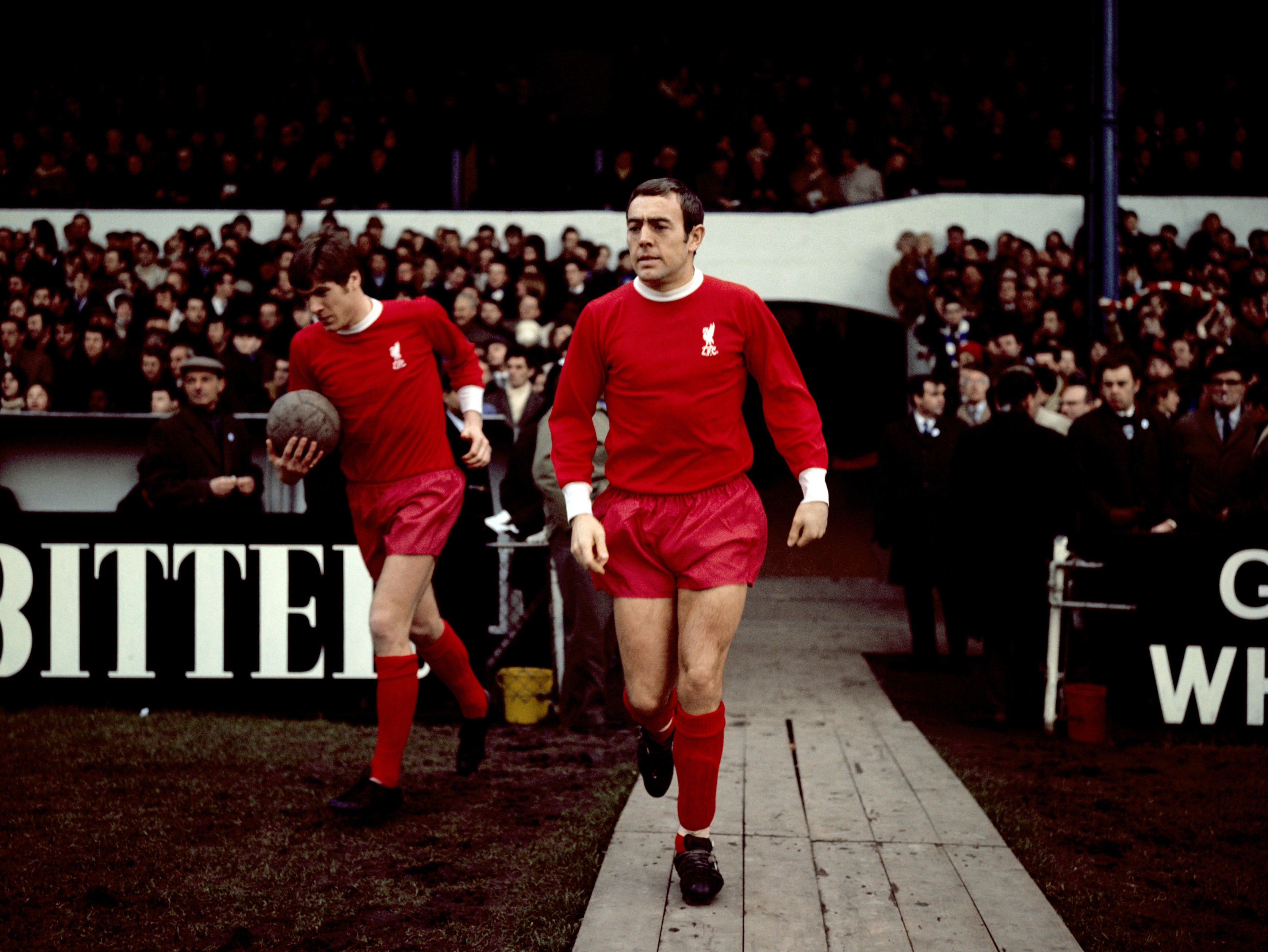 St John (centre) walks out for the Reds in 1969