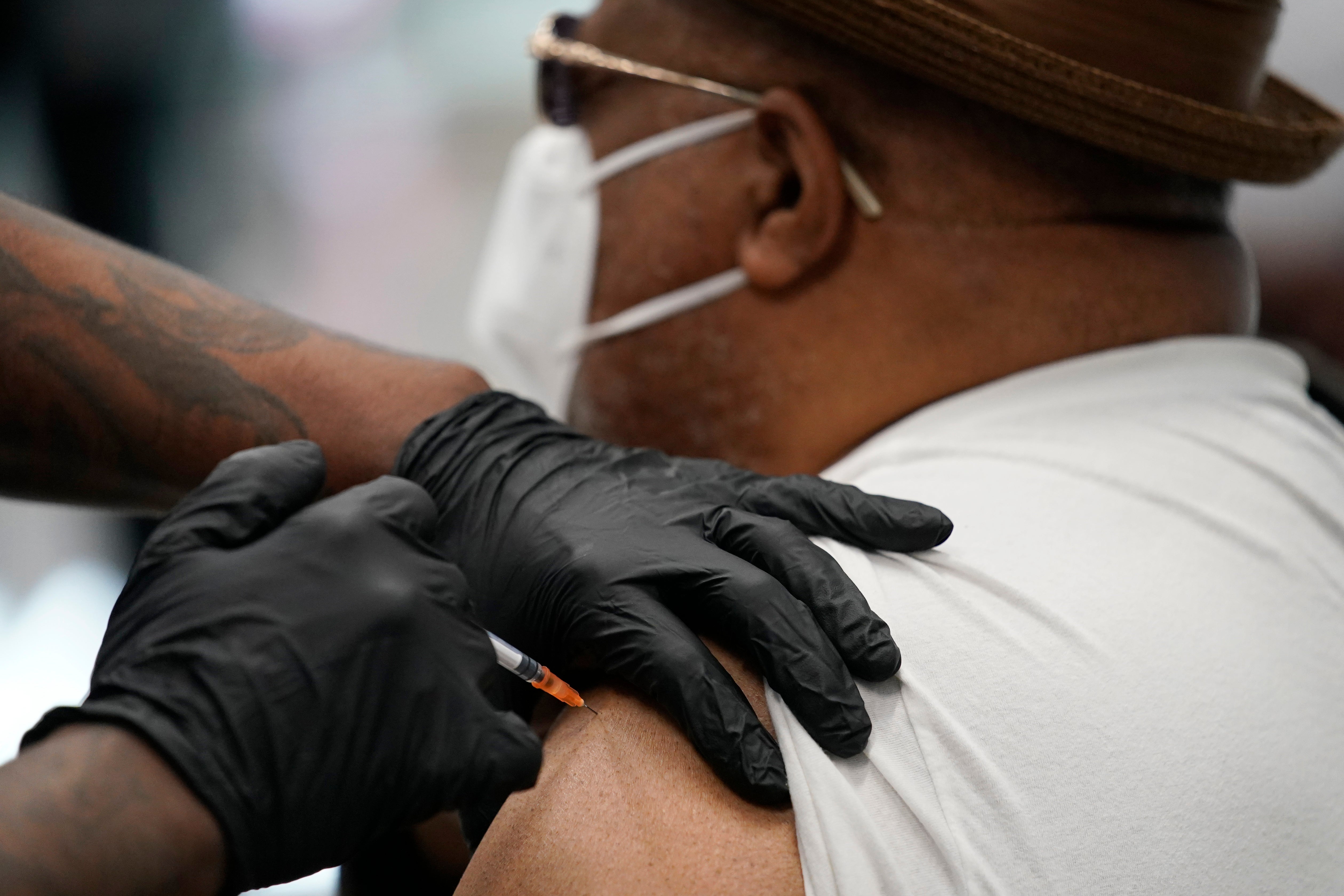FILE - A man receives a COVID-19 vaccine in North Las Vegas on 10 February. New Zealand will vaccinate its 5 million population with Pfizer