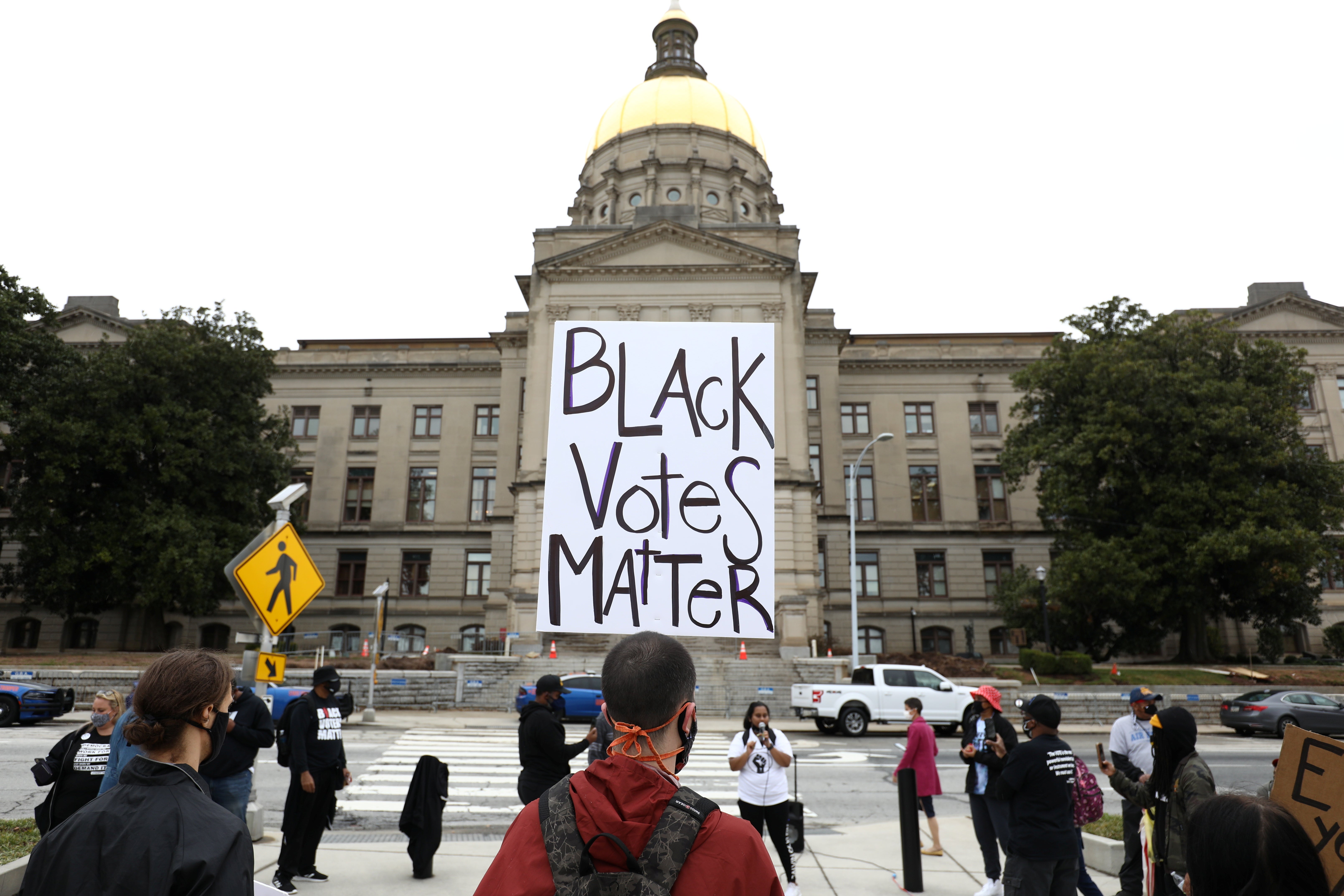 Demonstrators protest a sweeping elections bill to place greater restriction on voting in Georgia, one of more than 40 states where Republicans are proposing new restrictions on voting rights following 2020 elections.