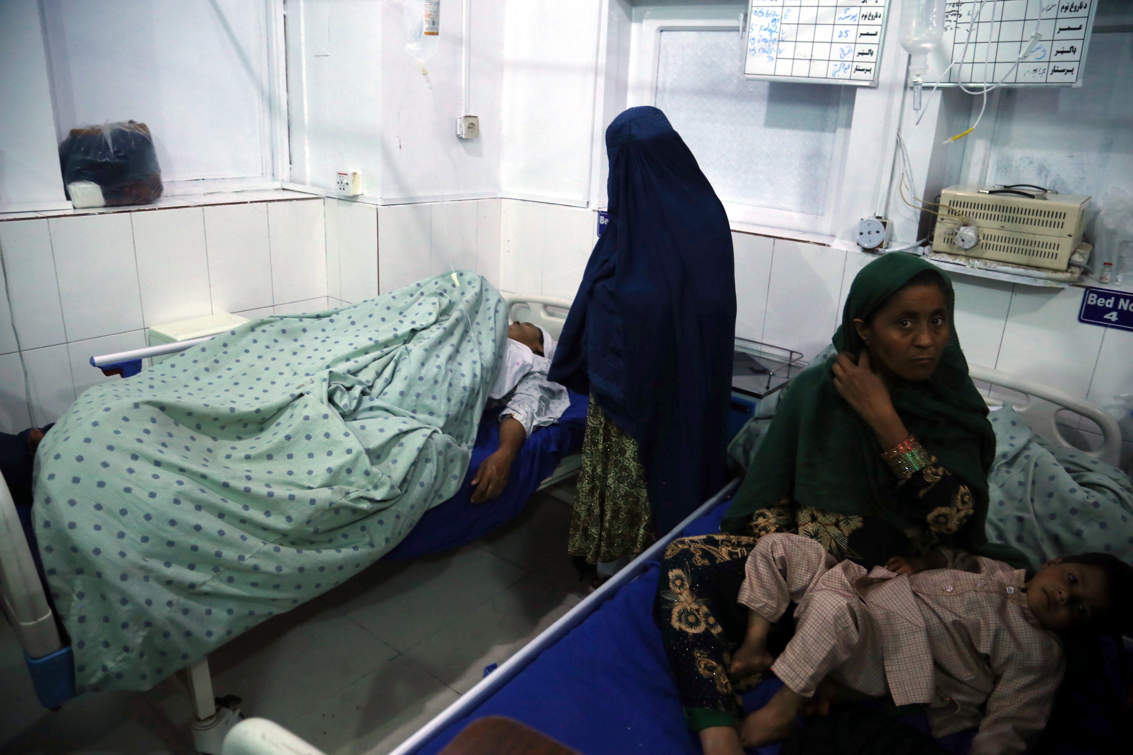 An Afghan woman who was injured when unknown gunmen opened fire and killed Afghan female journalists of Enikas Radio Television Network, receives medical treatment at a hospital, in Jalalabad, Afghanistan