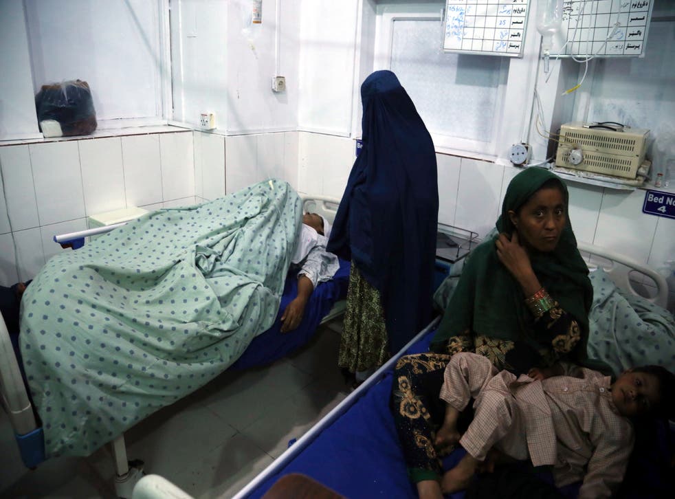 <p>An Afghan woman who was injured when unknown gunmen opened fire and killed Afghan female journalists of Enikas Radio Television Network, receives medical treatment at a hospital, in Jalalabad, Afghanistan</p>