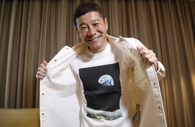 <p>Japanese billionaire Yusaku Maezawa poses with his T-shirt bearing an image of Earth during an interview with Reuters in Tokyo, Japan on 3 March 2021 </p>