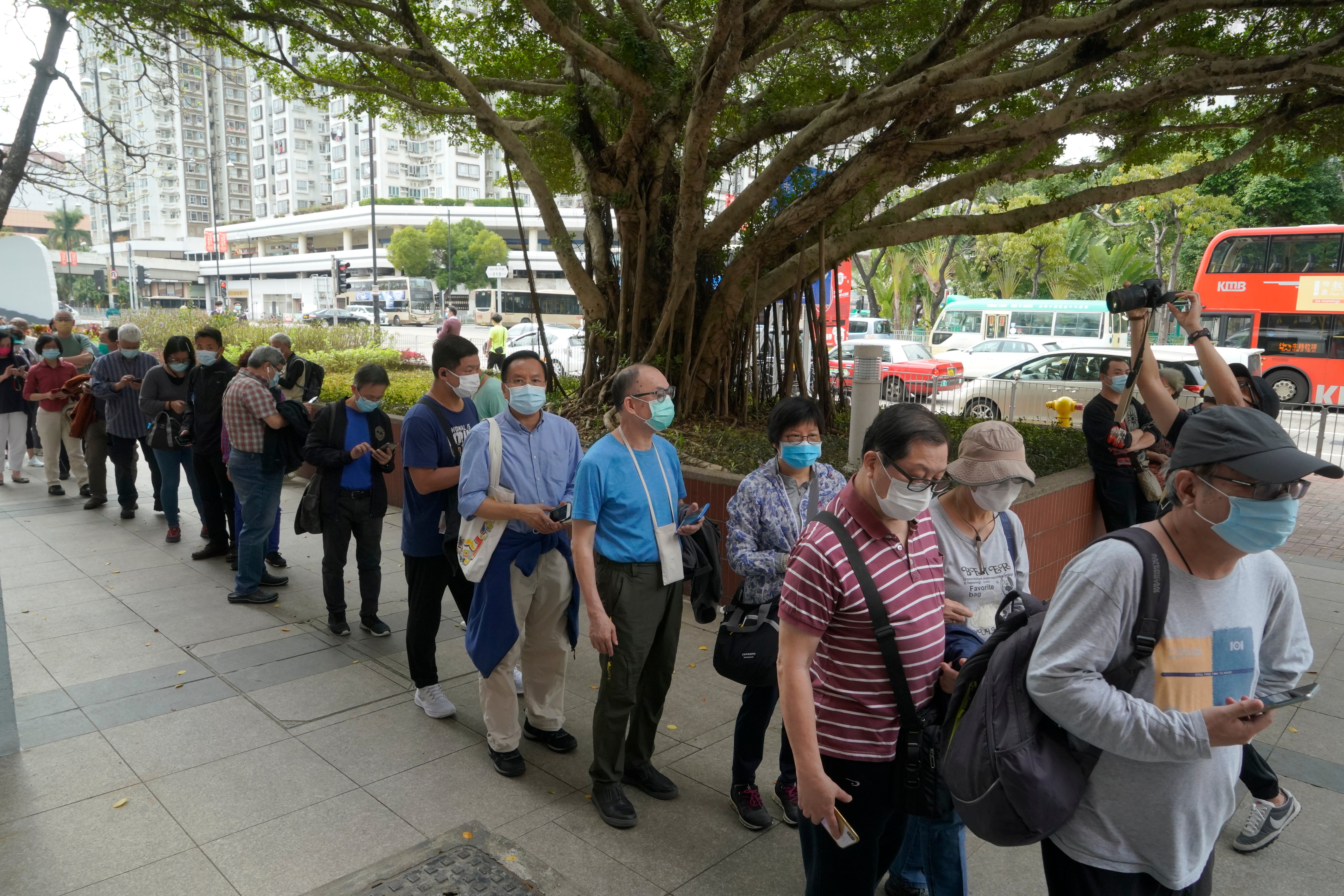 File image - People line up to receive China's Sinovac coronavirus vaccine at a community vaccination centre in Hong Kong on 26 February