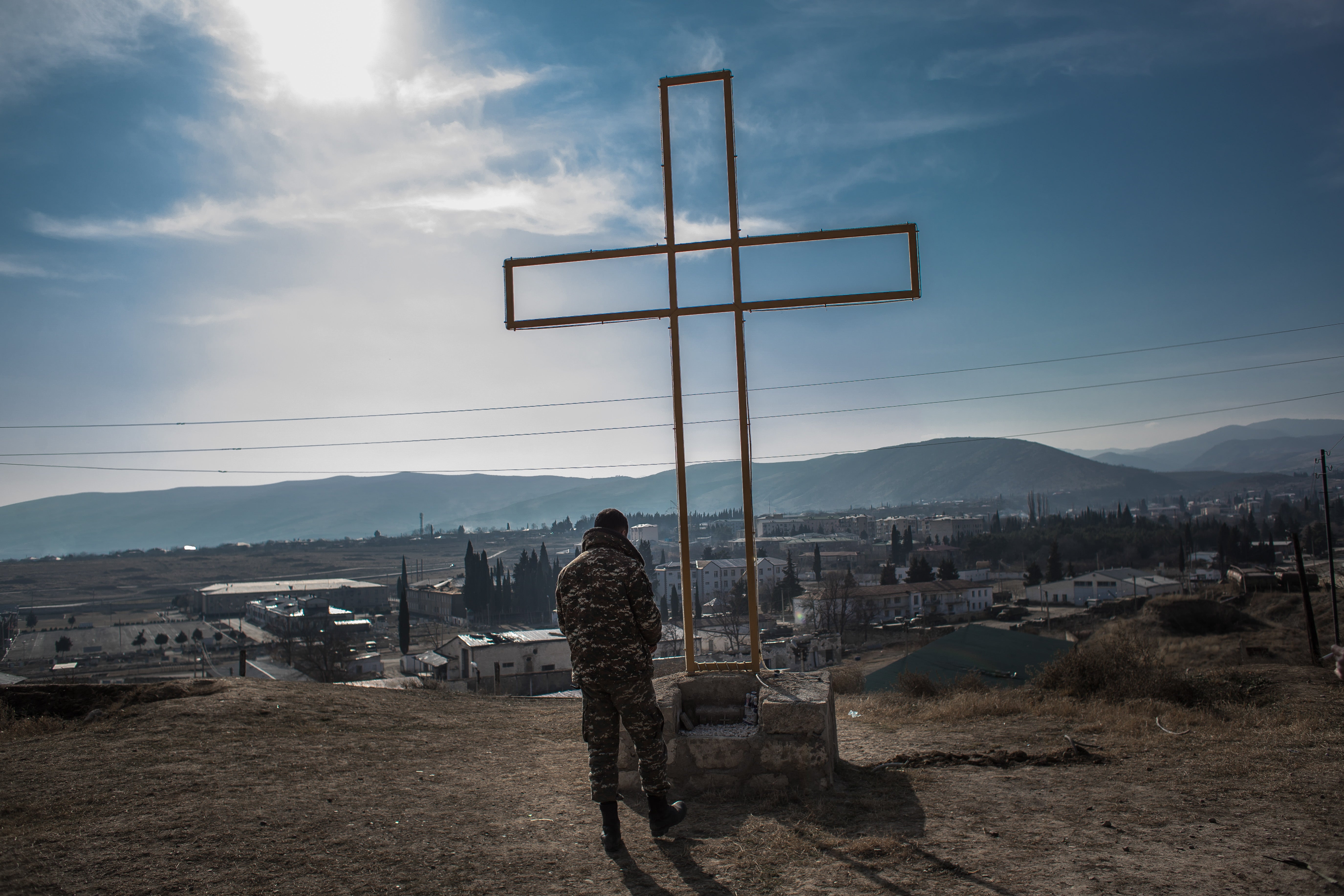 An Armenian soldier prays in front of a cross at a military position in Martakert in Nagorno-Karabakh on 17 January