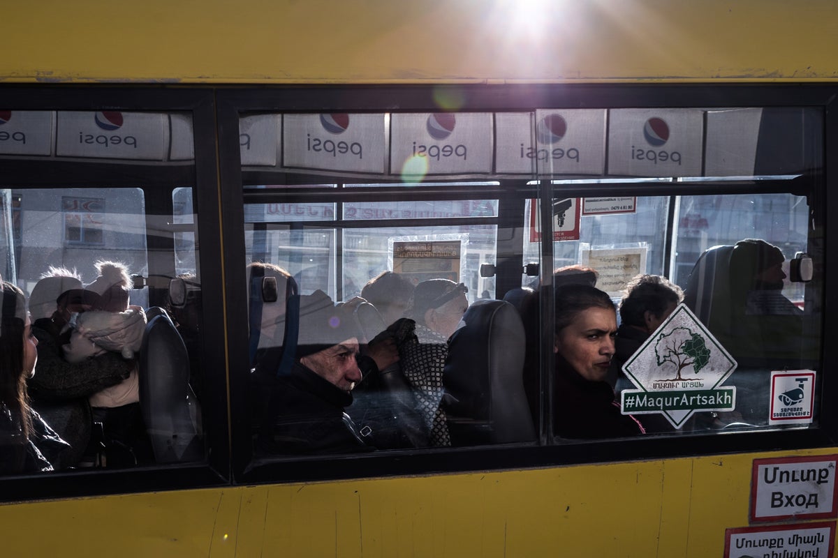Passengers sit in a bus at a bus station in Stepanakert, de facto capital of Nagorno Karabakh. The conflict pushed some 70,000 people out of the territory into Armenia during the conflict
