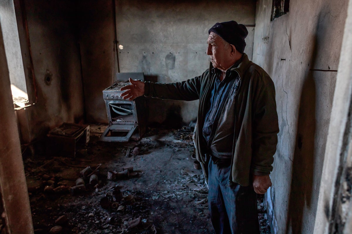 Hratchik Avakian, a retired grocer, stands in his house in Martuni destroyed by shelling on 27 September