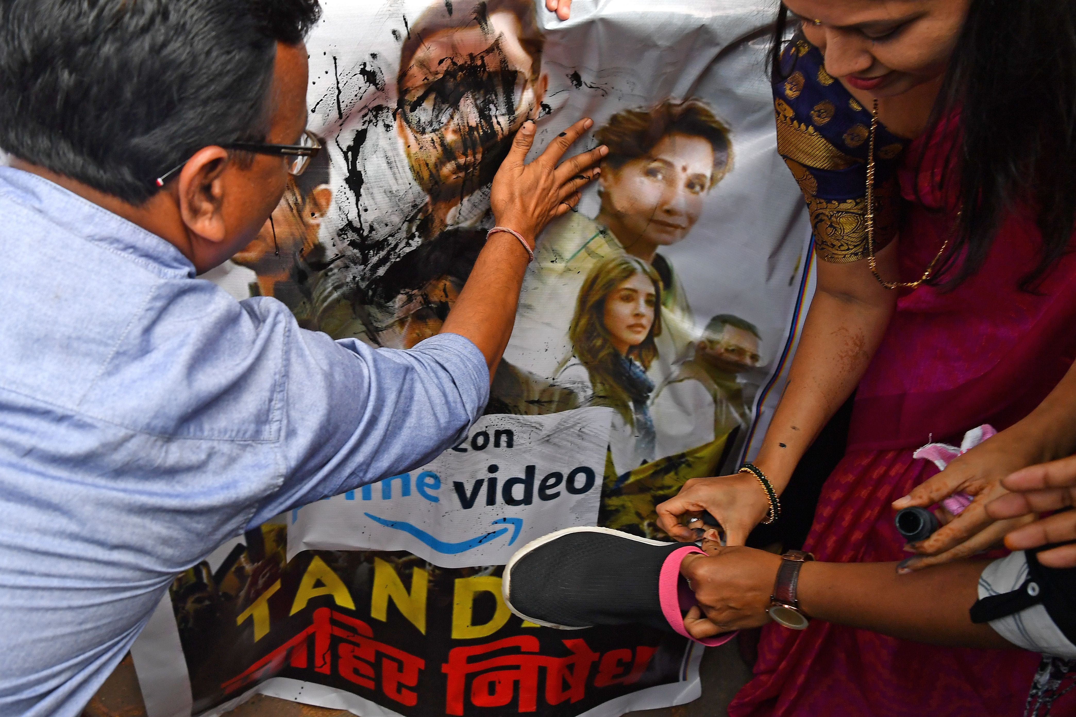 Supporters of India’s ruling Bharatiya Janata Party (BJP) pour ink and beat a poster with footwear at a protest against the new web series ‘Tandav’ in Mumbai