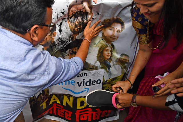 <p>Supporters of India’s ruling Bharatiya Janata Party (BJP) pour ink and beat a poster with footwear at a protest against the new web series ‘Tandav’ in Mumbai</p>