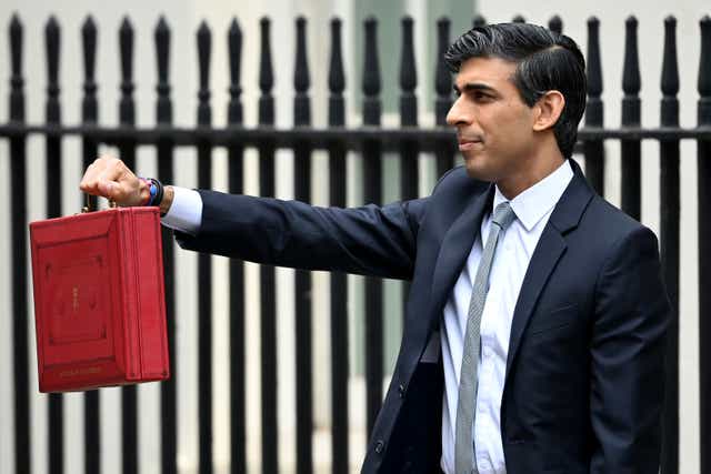 <p>Chancellor Rishi Sunak, holds the budget box before delivering the annual Budget at 11 Downing Street</p>