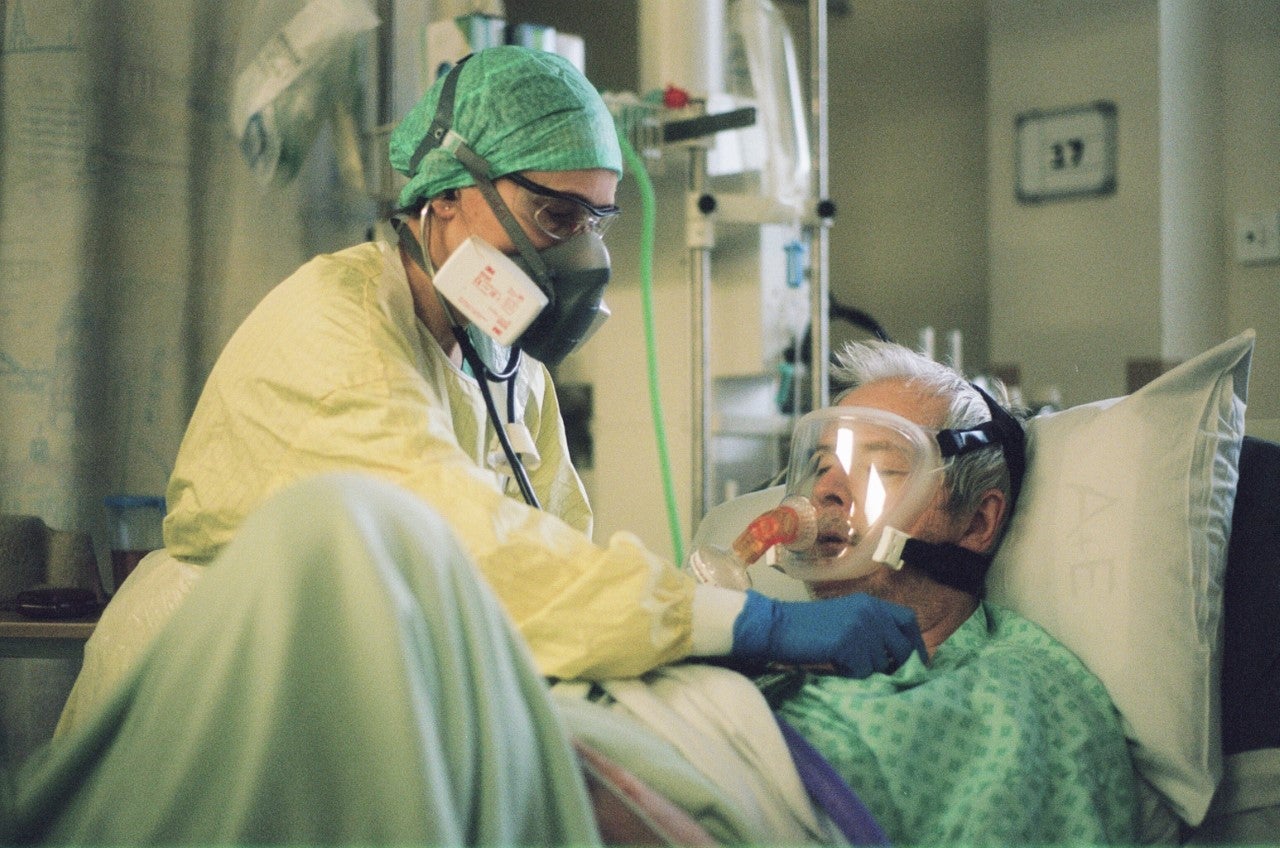 Consultant Intensivist examines a patient with Covid-19